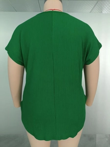 Detail view of dark green plus size top with textured vertical pleated fabric and back seam