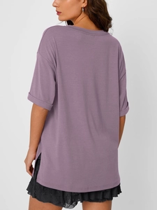 Detail view of purple oversized T-shirt with deep side slits and rolled cuff sleeves