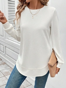 Detail of white waffle knit sweatshirt featuring a round neck and drop shoulder design