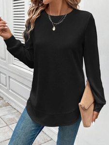 Detail of black waffle knit texture on women long sleeve sweatshirt with curved hemline