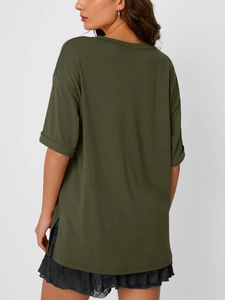 Detailed side view of dark green V-neck T-shirt showing split hem and rolled cuffs