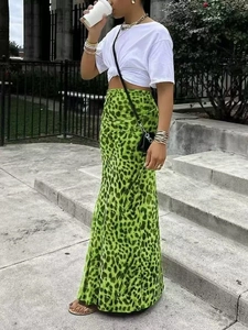 Macro detail of high-waist leopard print midi skirt in vibrant green chiffon fabric