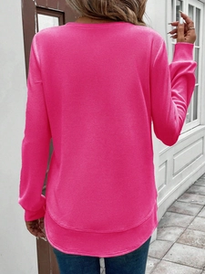 Back view of pink waffle knit long sleeve top featuring curved hem and ribbed cuffs