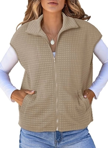 Detailed close-up of khaki quilted vest featuring a stand-up collar and smooth metal zipper