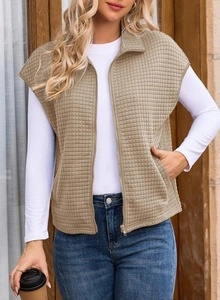 Detail of khaki quilted waffle vest showing high-quality zipper and textured fabric
