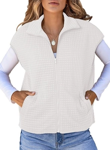 Detailed macro view of the white quilted vest fabric and zipper closure on sweatshirt