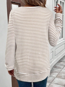 Detalle del tejido de punto y rayas beige en la espalda de un top de manga larga para mujer