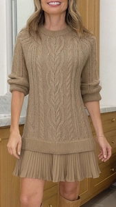 Detail view of the chunky cable knit texture and flowing pleated hem on this khaki dress