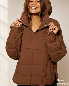 Detail of brown quilted anorak hoodie featuring snap button neck and grid stitching texture