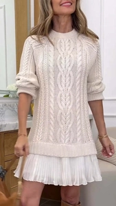 Detail of cable knit texture and pleated chiffon hem on a cream mini dress