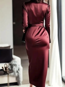 Detail of burgundy satin dress showing the silky texture and elegant waist-tie design