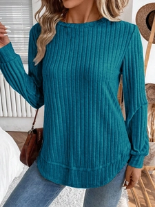 Close-up of the ribbed texture and peacock blue fabric on this long sleeve knit top