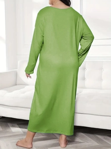 Rear view of long sleeve grass green maxi dress with loose fit and crew neck style