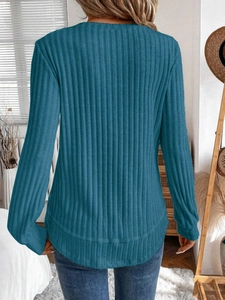 Detailed back view of peacock blue ribbed knit sweater with a curved hemline and soft texture