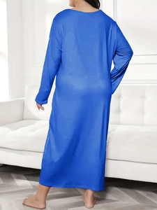 Macro view of blue long-sleeve oversized dress with soft modal texture and elegant drape
