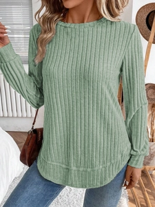 Detail shot of light green ribbed knit texture on a long-sleeved round neck sweater