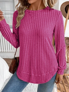 Detail showing the ribbed texture and curved hem of this rose red long sleeve knit top
