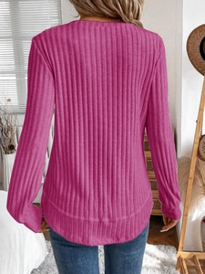 Detail shot of the ribbed texture and fitted back of the magenta crewneck sweater