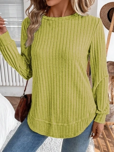 Detail showing grass green ribbed knit sweater fabric and curved hem design