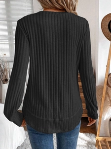 Back view of black long-sleeve ribbed knit top with a curved hem design