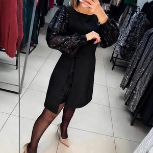 Elegant black bodycon dress featuring sheer sequin puff sleeves for party wear