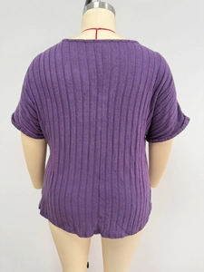 Back view of plus size dark purple ribbed knit top showing loose fit and dropped shoulders
