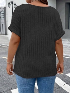 Back view of black ribbed knit plus size top with drop shoulder and rolled sleeve cuffs