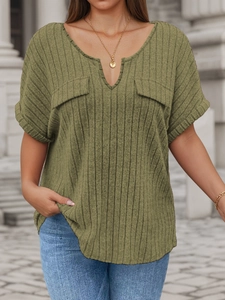 Detail view of olive green ribbed knit texture and notched V-neck with faux pockets