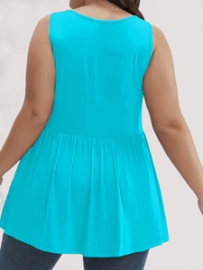 Detail view of the pleated back and flared hemline on a blue sleeveless plus size tunic