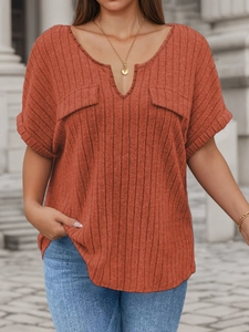 Detail of V-neckline and textured ribbed knit fabric on the loose burnt orange summer top
