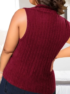 Detail of burgundy ribbed knit sleeveless top with mock neck and textured fabric