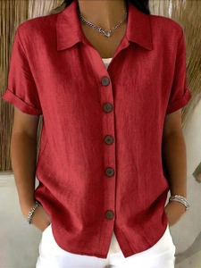 Detail of red short sleeve shirt showing linen texture and dark brown buttons