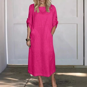 Detail of hot pink linen dress featuring roll-up sleeves and functional side pockets