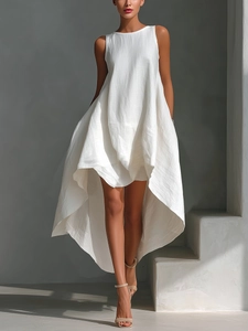 Detail of white cotton linen sleeveless dress showing high-low hem and texture