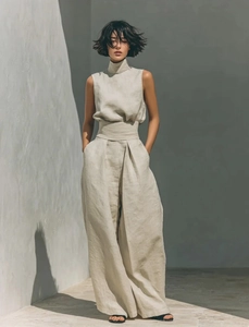 Detail of linen-blend sleeveless top and high-waisted wide-leg trousers set in beige