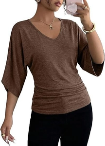 Detail of V-neck brown top featuring ruched side waist and stylish batwing sleeves