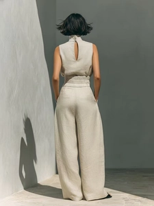 Rear view detail of beige linen sleeveless wide-leg set with high neck and back opening