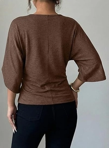 Detailed back view of a brown knit V-neck top with drop shoulders and a center seam detail