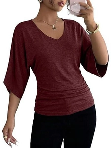 Close-up of ruched side detailing and V-neckline on a wine red short-sleeve top