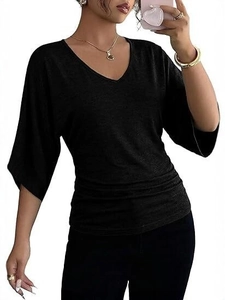 Detail of black V-neck top showing ruched waist design and textured batwing sleeves