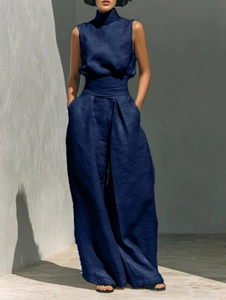 Detail of dark blue linen sleeveless high-neck top with wide-leg trousers texture
