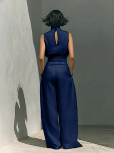 Detail of the back cutout and high-waisted elastic band of this navy linen set