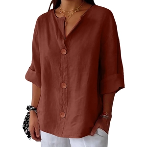 Detail of V-neck cotton linen shirt featuring large wooden buttons and natural fiber texture