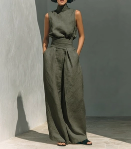Detailed texture of olive green linen fabric on high-neck top and wide-leg trousers