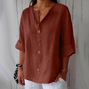 Detail of V-neck buttoned shirt in brick red linen fabric with decorative wooden buttons