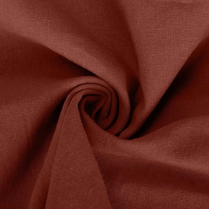Detailed macro shot of deep rust red linen fabric showing texture and drape quality