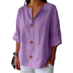 Detailed view of purple V-neck linen top featuring decorative buttons and rolled sleeves