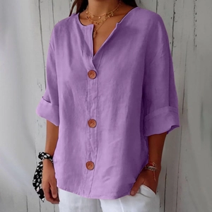 Detailed close-up of light purple linen V-neck shirt with natural wood buttons and rolled sleeves