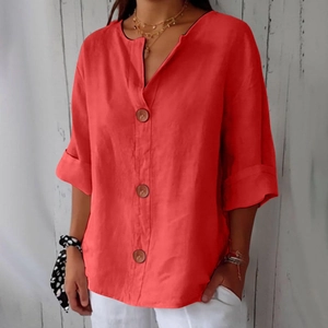 Close-up of V-neck cotton linen blouse with natural wood buttons and folded sleeve detail