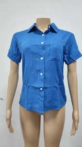 Close-up of royal blue cotton linen shirt showing front pocket and white resin buttons